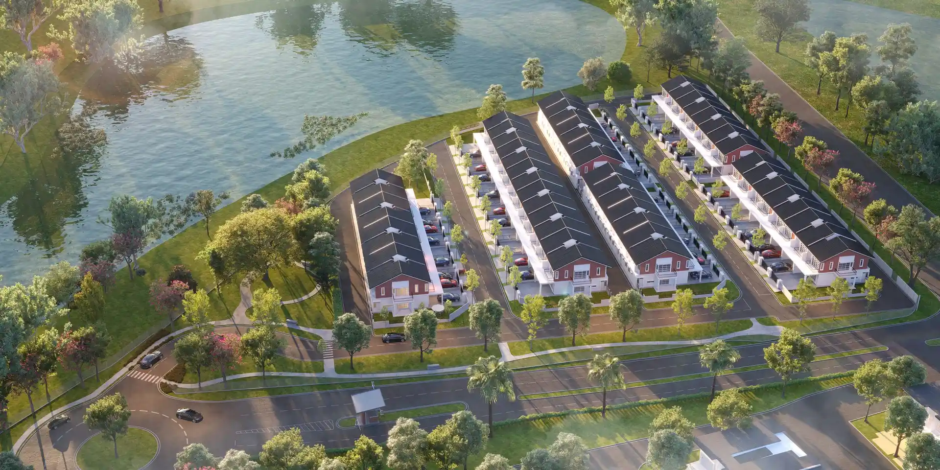 Aerial view of Kensington 3 English-brick terrace homes beside a lake in Genting Indahpura, Kulai
